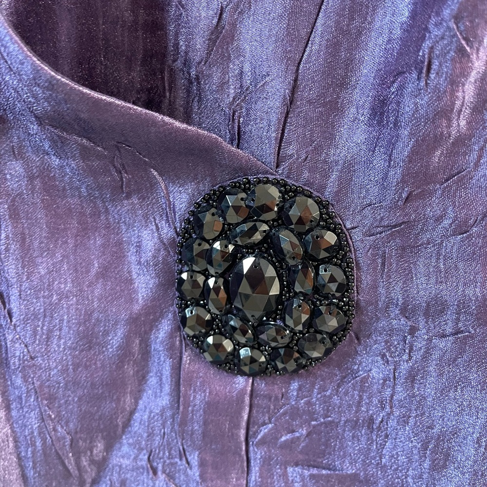Dressy lightweight top with lovely embellishment.